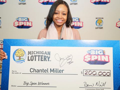 Chantel Miller holding big check after winning on The Big Spin Show